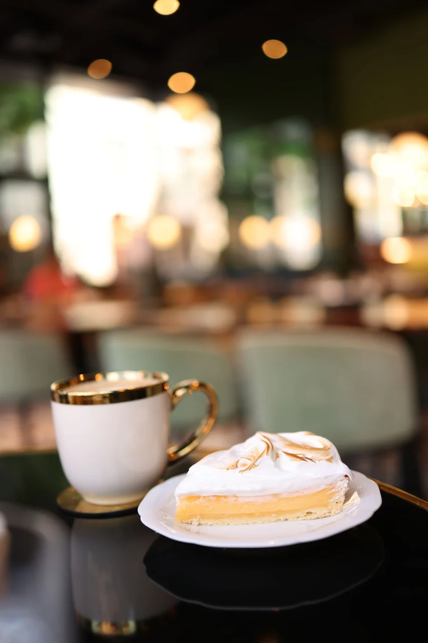 Dessert and cup in warm cafe light