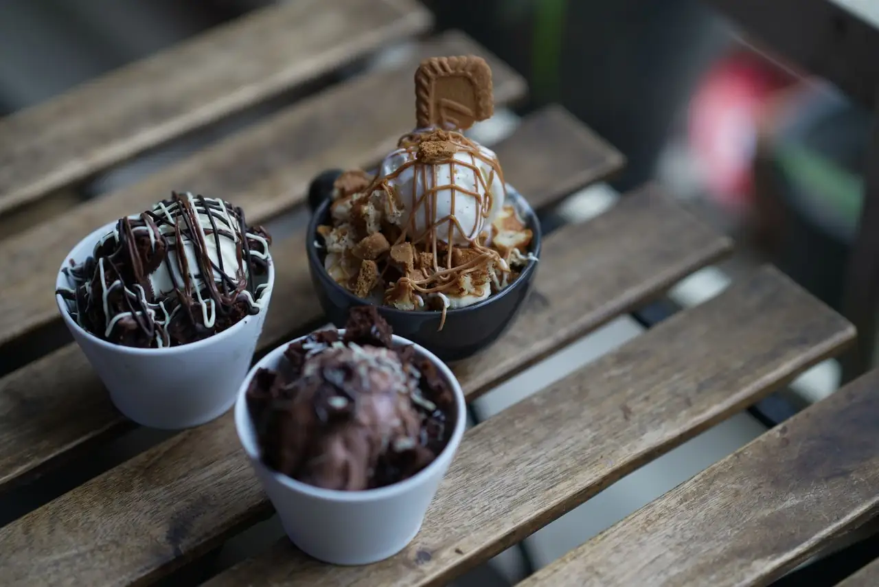 Friends sharing ice cream bowls